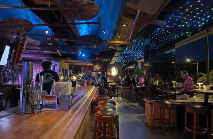 Interior of Hula's Bar and Lei Stand in Honolulu. Gay bar with music, drinks, and tropical decor. Popular gay travel destination.