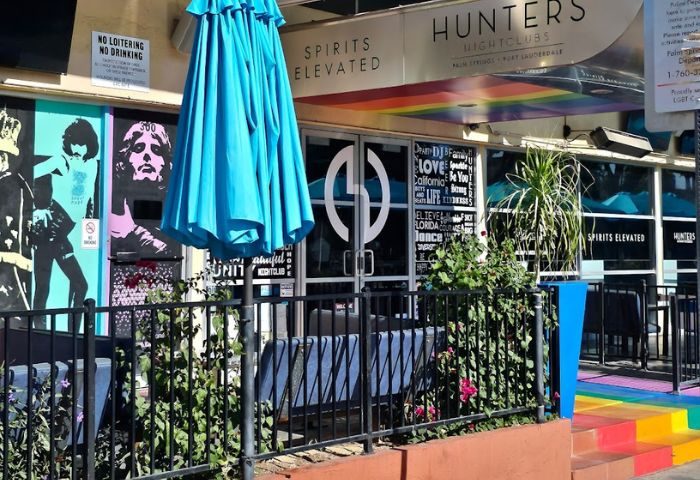 Hunters Nightclub location. Gay bar exterior with rainbow steps. Palm Springs, Fort Lauderdale LGBT nightlife. Spirits Elevated.