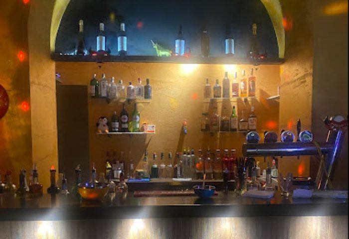 Il Diavolo Dentro bar in Rome: Bottles of liquor and beer taps line the bar at this gay-friendly travel destination. Nightlife in Italy.