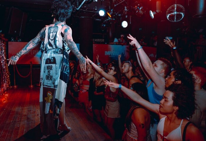 Drag queen on stage at Imperial Erskineville, Sydney. Crowd cheers at gay bar. Nightlife travel advice for gay men.
