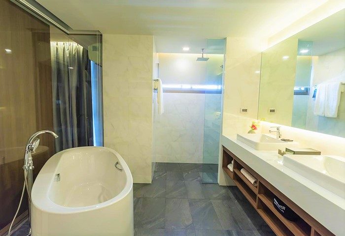 Luxury hotel bathroom in Chiang Mai, Thailand. Bathtub, shower, and double sinks. Gay travel goals. Nimman hotel stay.
