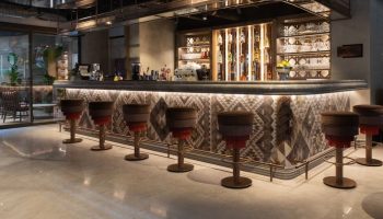 Burdock Hotel Istanbul bar. Chic interior, perfect for Instagram. Stylish stools line the bar. Gay travel. Autograph Collection hotel.