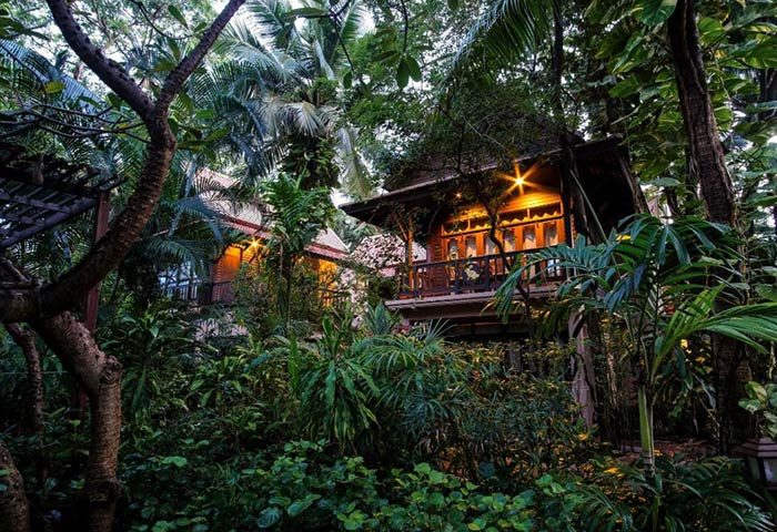 Rabbit Resort, a Thai-style gay hotel in Pattaya, near Dongtan Gay Beach. Lush tropical foliage surrounds wooden structures with balconies.