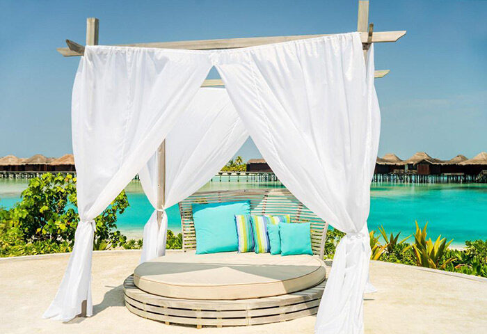 Anantara Veli Maldives Resort beachfront cabana. Instagramable gay hotel with cheap price, turquoise water, and overwater bungalows.
