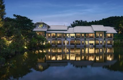 InterContinental Khao Yai Resort view. Best gay hotels near Bangkok, Thailand. Mountains, lake, and luxury resort reflected in water.