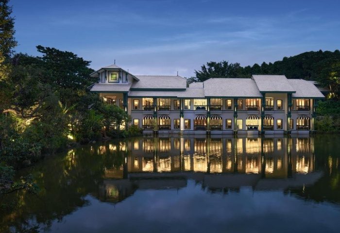InterContinental Khao Yai Resort view. Best gay hotels near Bangkok, Thailand. Mountains, lake, and luxury resort reflected in water.