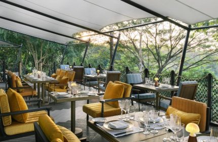 InterContinental Khao Yai Resort's outdoor dining area. Cool design hotel in the jungle. Tables are set for a meal with a view. Gay travel.