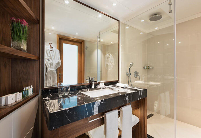 Isrotel Tower Tel Aviv bathroom. Modern design, marble countertop, glass shower. Popular gay hotel with luxurious amenities.