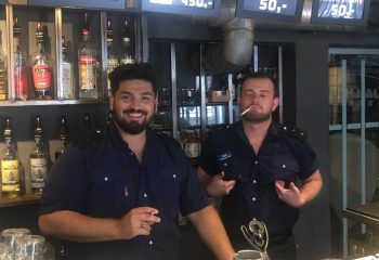 Jailhouse CPH, Copenhagen: Two attractive bartenders in uniform at the Jailhouse bar. Gay travel advice for the best gay bars.