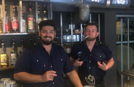 Jailhouse CPH, Copenhagen: Two attractive bartenders in uniform at the Jailhouse bar. Gay travel advice for the best gay bars.