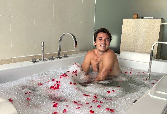 Gay travel: Jared Reinfeldt enjoys a bubble bath with rose petals at Vana Belle, a Luxury Collection Resort in Koh Samui, Thailand.