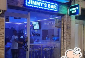 Jimmy's Bar in Benidorm. Exterior view of the gay bar with blue neon signage. A popular gay travel destination for men.