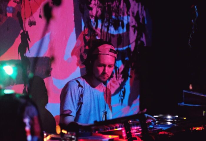 Jolene Bar Copenhagen DJ. Gay travel advice: DJ playing music at Jolene Bar in Copenhagen. Nightlife scene with colorful lighting.