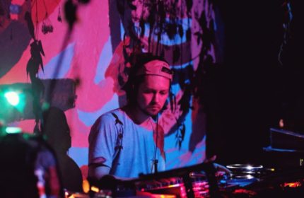 Jolene Bar Copenhagen DJ. Gay travel advice: DJ playing music at Jolene Bar in Copenhagen. Nightlife scene with colorful lighting.