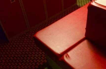 K-Men Club Rome locker room. Red lockers and a red bench in a gay sauna. Gay travel advice for men.