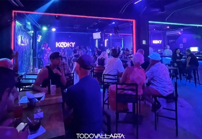 Kooky Karaoke in Puerto Vallarta: Patrons enjoy the lively gay bar with music, drinks, and a vibrant atmosphere in Zona Romantica.