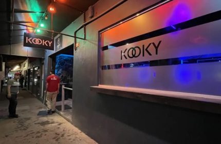 Kooky Karaoke entrance in Puerto Vallarta. Gay nightlife spot with colorful lights and a modern facade. Popular gay bar in Mexico.