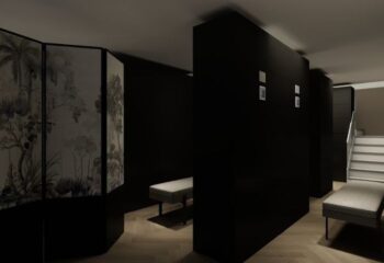 Interior of Kuma Club Las Vegas, a gay bathhouse. Dark walls, benches, and a decorative screen create a modern, intimate space.