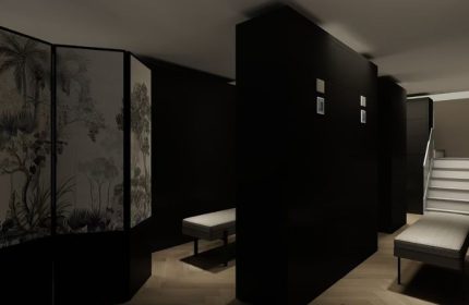 Interior of Kuma Club Las Vegas, a gay bathhouse. Dark walls, benches, and a decorative screen create a modern, intimate space.