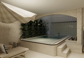 Kuma Club Las Vegas gay bathhouse: An indoor pool with a waterfall feature and a sun umbrella, offering a relaxing spa experience.