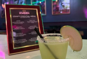 Kween Bar's craft cocktail menu in Montreal. A cocktail with a salted rim & apple slice. Gay bar travel advice.