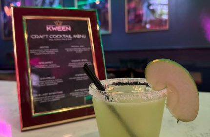Kween Bar's craft cocktail menu in Montreal. A cocktail with a salted rim & apple slice. Gay bar travel advice.