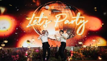 Gay wedding at Pullman Bangkok King Power. Two grooms celebrate under confetti and a disco ball. Let's Party in neon lights.