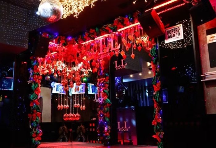 LL Bar, a gay bar in Madrid, Spain. Entrance decorated with lights, garlands, and a disco ball. Nightlife for gay men travelers.
