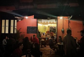 La Botica Gay Bar in Mexico: A lively scene at a popular gay bar in Mexico, patrons enjoying drinks in a cozy, dimly lit setting.