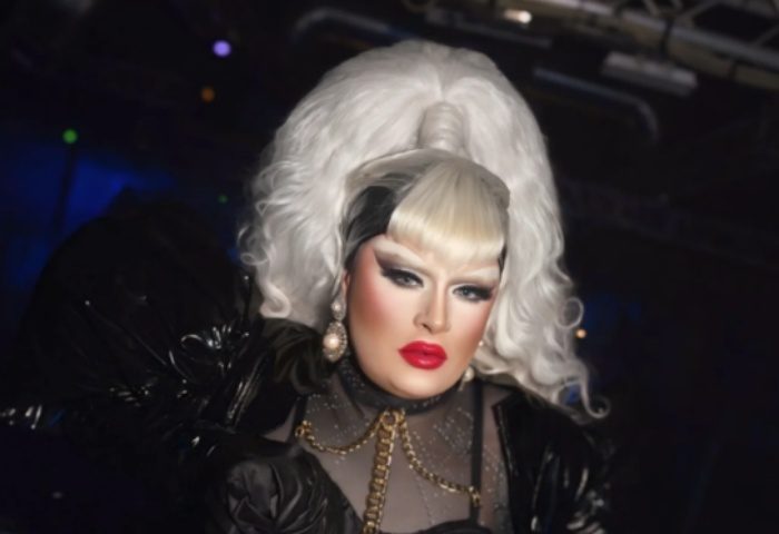 Drag queen in Milano's La Boum. White hair, red lips, and black outfit. Gay nightlife in Italy. LGBTQ+ travel.
