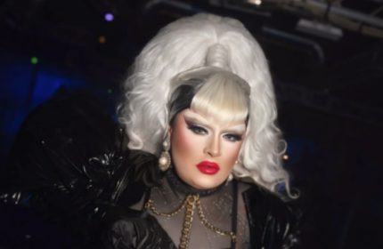 Drag queen in Milano's La Boum. White hair, red lips, and black outfit. Gay nightlife in Italy. LGBTQ+ travel.