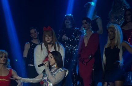 La Boum Milano: Drag queens perform on stage. Gay nightlife in Milan, Italy. LGBTQ+ travel advice. Performers in glamorous outfits.