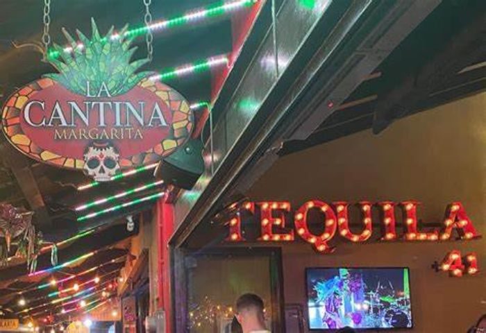 La Cantina Margarita gay bar in Puerto Vallarta. Tequila sign, skull logo, and colorful lights. Gay travel destination.
