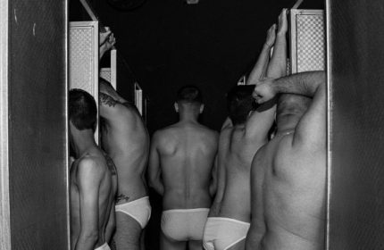 Monochrome shot of men in underwear at La Casita gay bar, CDMX, Mexico. Dark, intimate setting; travel advice for gay men.
