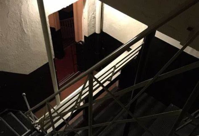 Stairwell at La Casita, a gay bar in Mexico City's Zona Rosa. Dark interior with metal railings and a view down the stairs. CDMX gay nightlife.