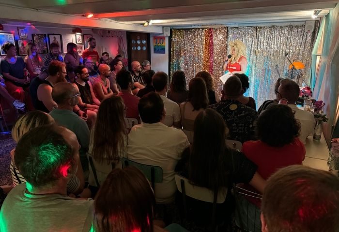 La Federica gay bar in Barcelona: Drag queen performing on stage to an audience. Gay travel advice for Barcelona's gay scene.