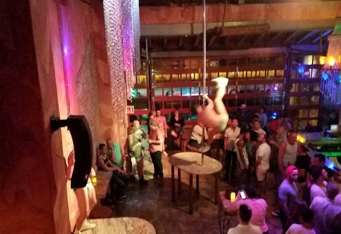 La Noche Gay Bar in Puerto Vallarta: Pole dancer performs for a lively crowd at the popular gay bar. Nightlife scene, travel advice.