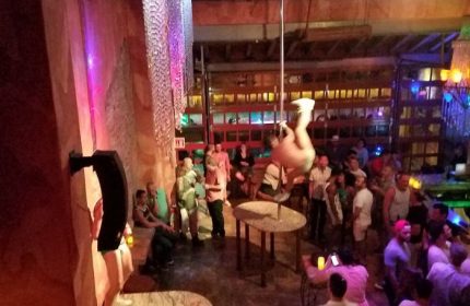 La Noche Gay Bar in Puerto Vallarta: Pole dancer performs for a lively crowd at the popular gay bar. Nightlife scene, travel advice.