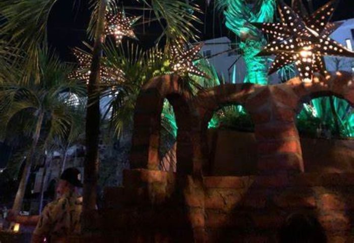 La Noche Gay Bar in Puerto Vallarta: Star lanterns illuminate the outdoor patio at this popular gay bar. Palm trees add to the tropical vibe.