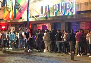 La Purisima Gay Bar in Mexico. People line up outside the gay bar under rainbow flags. Gay travel advice.