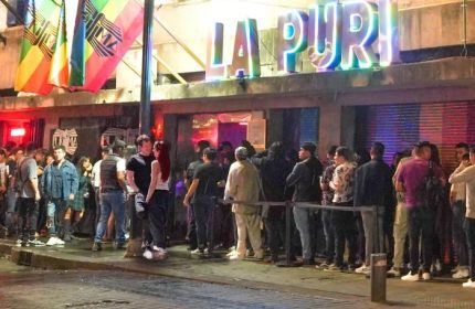 La Purisima Gay Bar in Mexico. People line up outside the gay bar under rainbow flags. Gay travel advice.