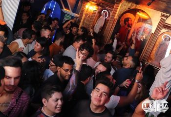 La Purisima Gay Bar in Mexico: A lively, crowded scene inside the popular gay bar. People are dancing and socializing under religious-themed decor.