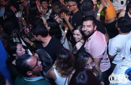 Crowded La Purisima gay bar in Mexico. Diverse group of people dancing, drinking, and enjoying the vibrant atmosphere. Gay travel nightlife.