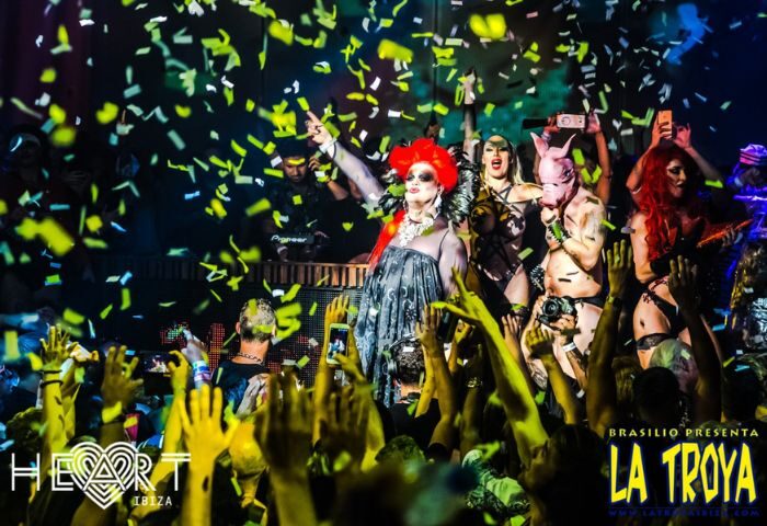 La Troya gay club in Ibiza's Heart nightclub. Drag queens and performers entertain a crowd under falling confetti. Gay travel.