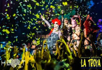La Troya gay club in Ibiza's Heart nightclub. Drag queens and performers entertain a crowd under falling confetti. Gay travel.