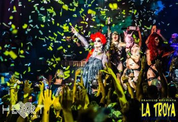 La Troya gay club in Ibiza's Heart nightclub. Drag queens and performers entertain a crowd under falling confetti. Gay travel.