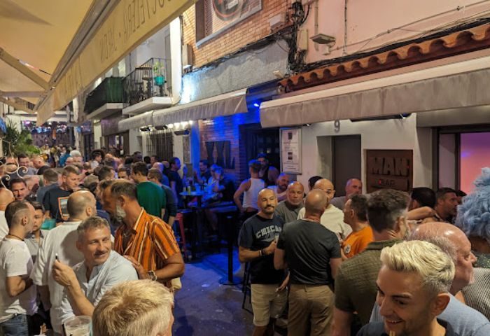 Crowded La Villa gay bar in Sitges, Spain. Men gather outside the popular gay bar in Sitges, a top gay travel destination.