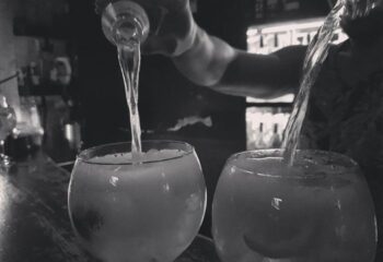 Bartender pouring drinks at La Kama Gay Bar in Madrid. A popular gay bar, cafe, and nightlife spot for gay men visiting Madrid.