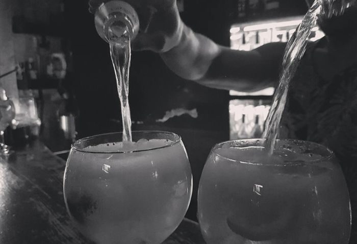 Bartender pouring drinks at La Kama Gay Bar in Madrid. A popular gay bar, cafe, and nightlife spot for gay men visiting Madrid.
