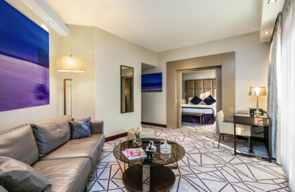 Carlton Tel Aviv Hotel suite living room. Luxury gay hotel with bedroom view. Modern design, perfect for gay travel.
